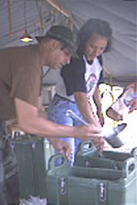 Mixing the drink for the evening meal at base camp Motagua for more than 250 Army Reserve soldiers on annual training at Puerto Barrios during New Horizons '99 exercises are Staff Sgt. Antonio Cotto, senior food sergeant, 983rd Engineer Battalion, Monclova, Ohio, and Maria Aguilar, Guatemalan KP.    The Guatemalan KPs and food service personnel often pitch in to assist each other when a job needs to be done.